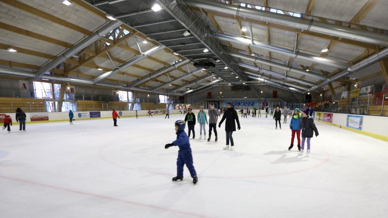 Eishalle Amstetten, © Gerhard Sengstschmied Menschen beim Eislaufen in einer großen Eishalle.