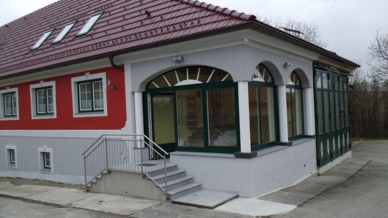 Ein modernes Gebäude mit rotem Dach und roter Fassade.